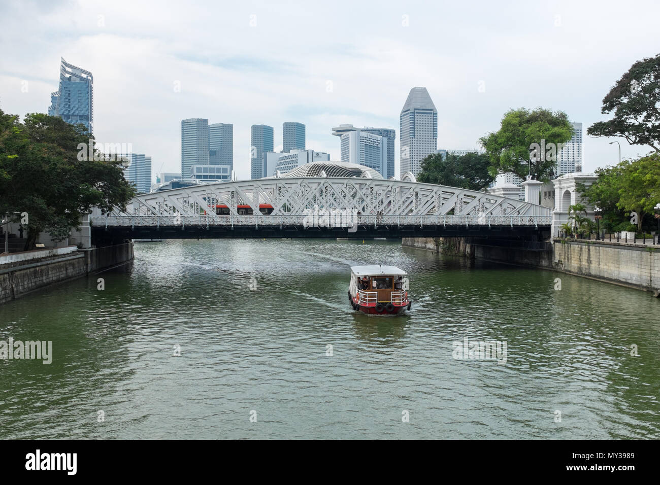 Touristen auf Bumboat vorbei unter Anderson Bridge auf dem Singapore River in Singapur Stockfoto