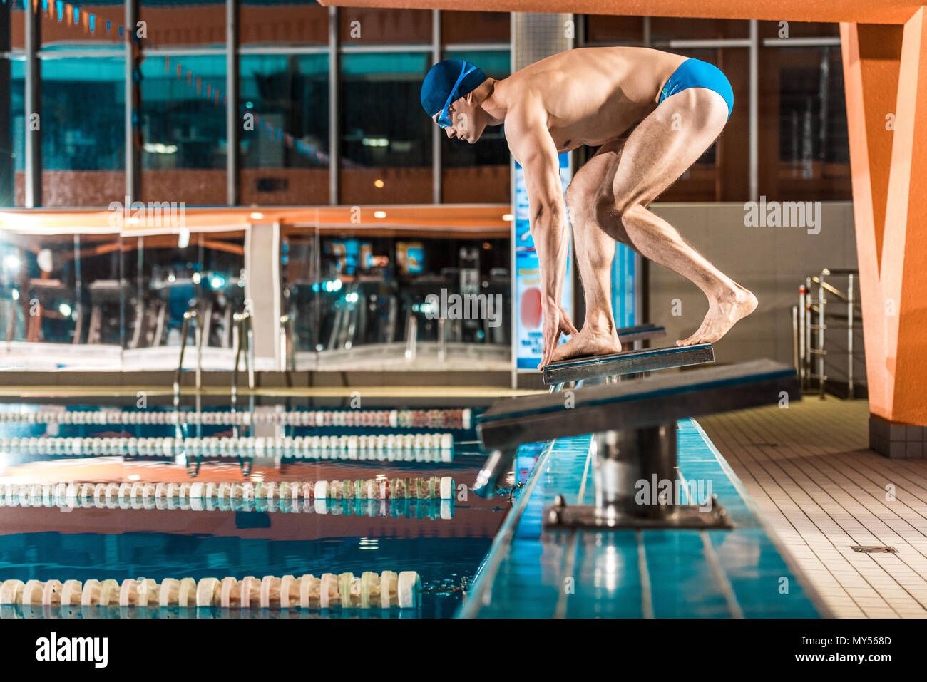Schwimmer stehen auf Sprungbrett in den Wettbewerb Pool zu springen Stockfoto
