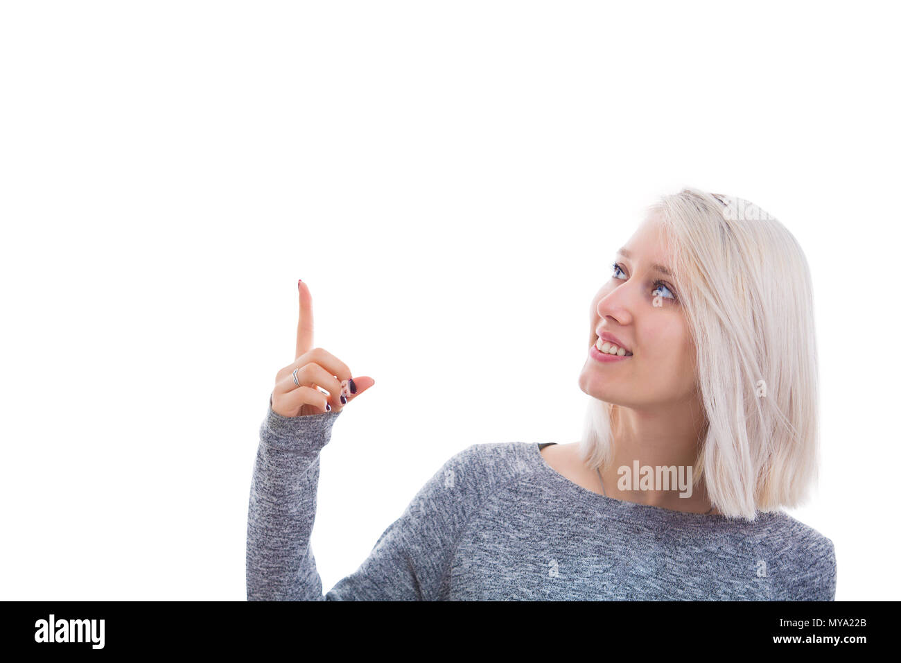Portrait Of Smiling Student Mädchen zeigen ihre Finger isoliert auf weißem Hintergrund. Schöne blonde Frau, mit dem Zeigefinger. Stockfoto