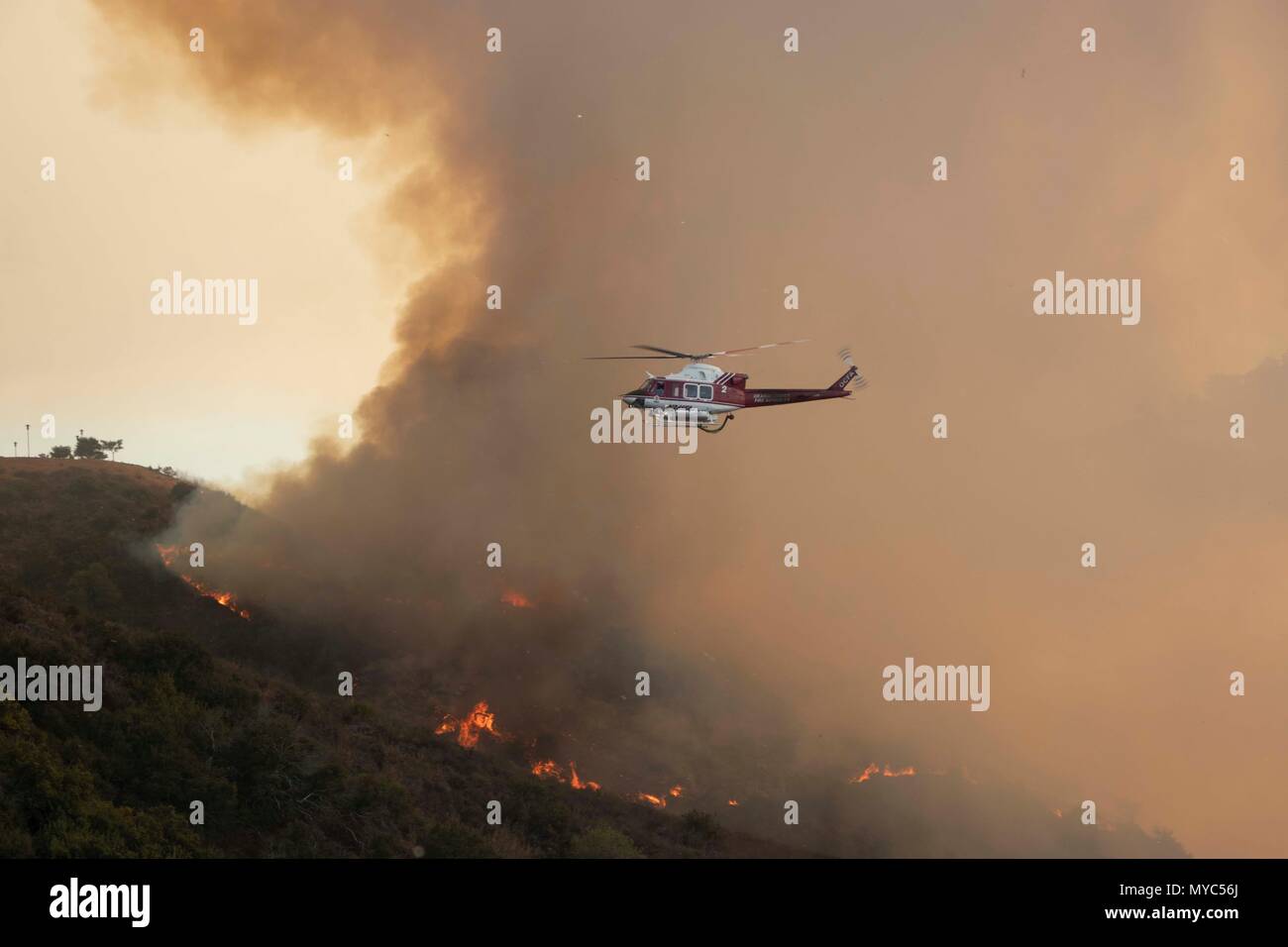 OCFA Feuer Hubschrauber fliegt durch Rauch, um zu helfen, die Aliso Viejo Bürste Feuer, dass am 2. Juni 2018 gestartet. Stockfoto
