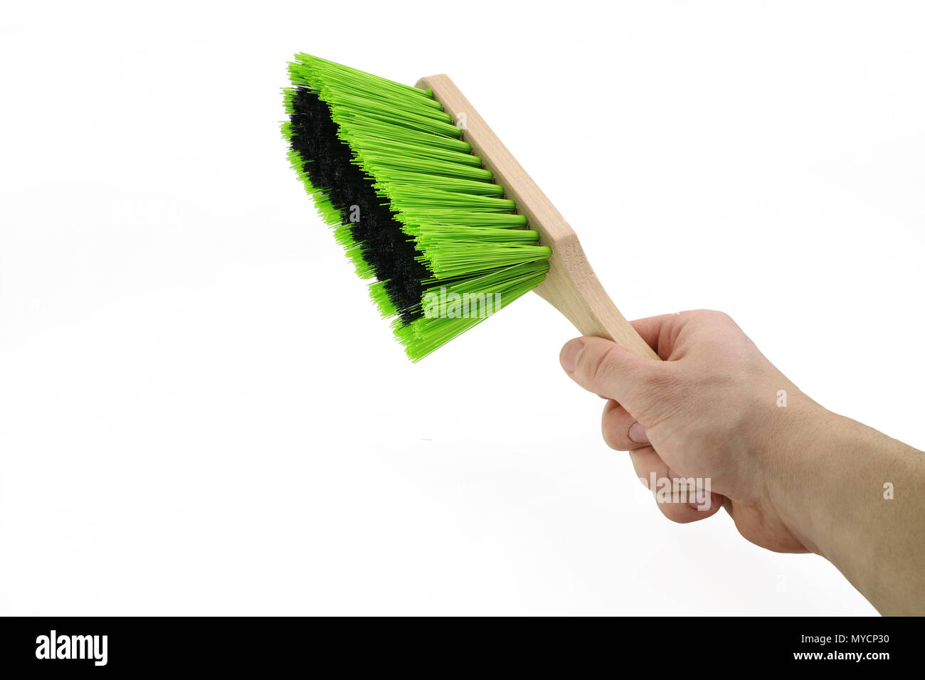 Hand hält eine grüne Staub Besen auf weißem Hintergrund Stockfoto