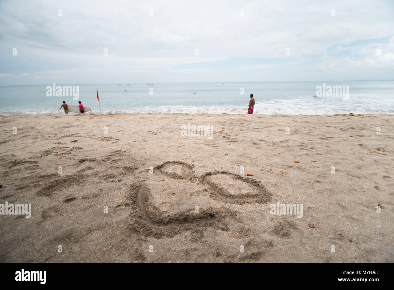 Glückliches Lächeln Gesicht Zeichnung im Sand Strand Stockfoto