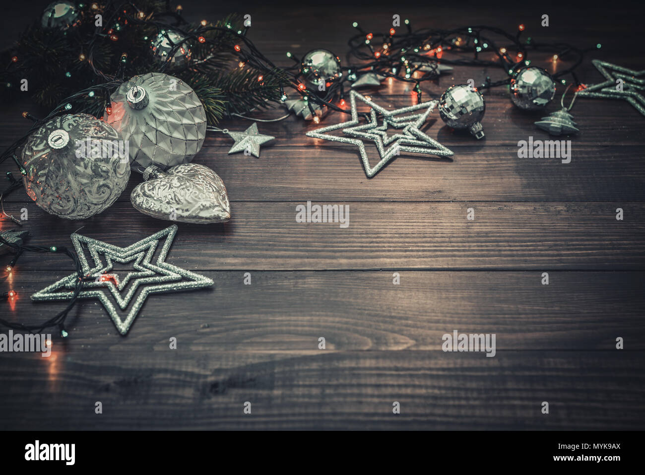 Weihnachtsschmuck mit Sternen, Tannenbaum, Zweige und Weihnachtslichter auf Holz- Hintergrund Stockfoto
