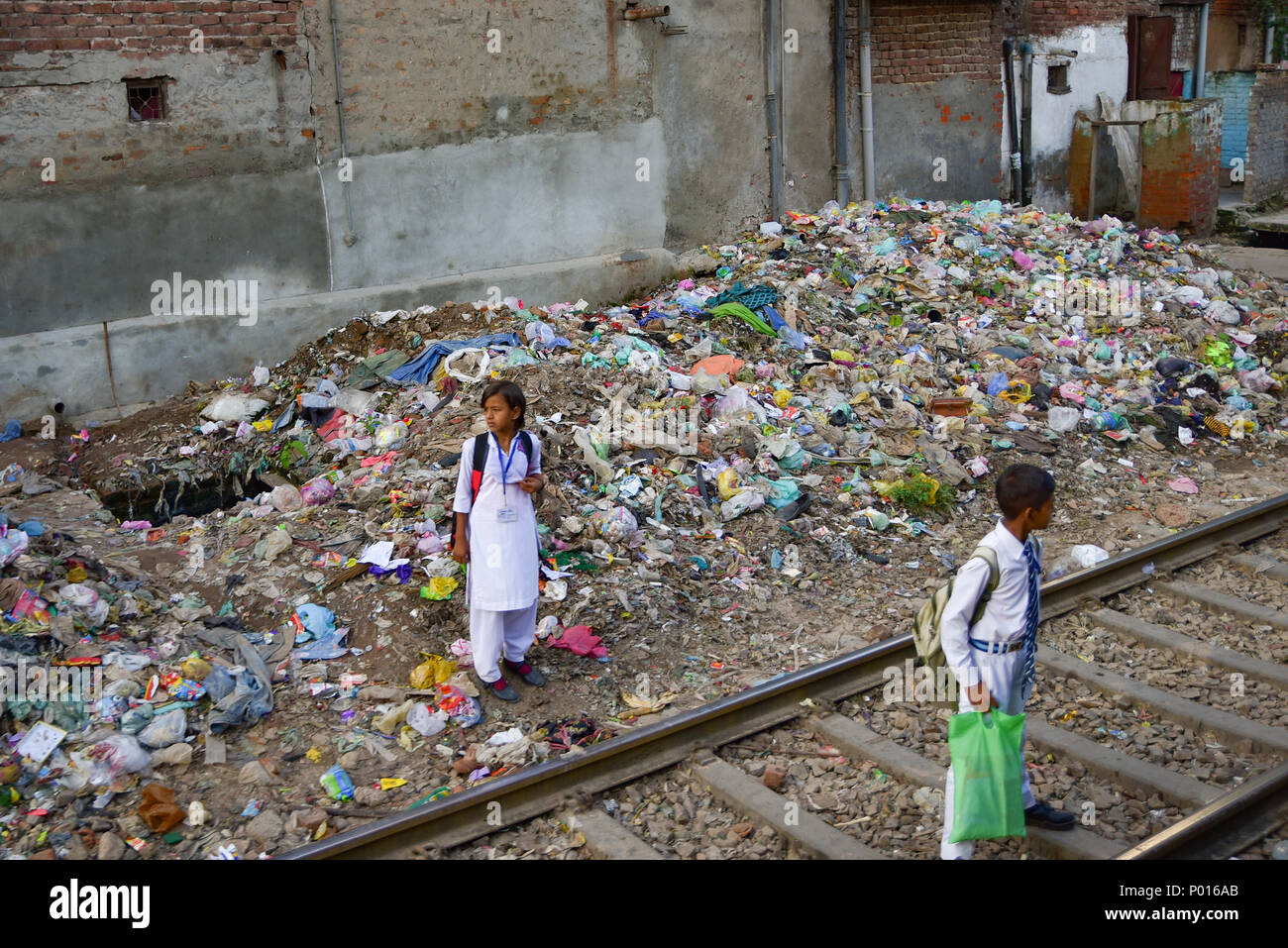 Indische Leute auf der Bahn mit Müll um in Neu Delhi, der Hauptstadt von Indien Stockfoto