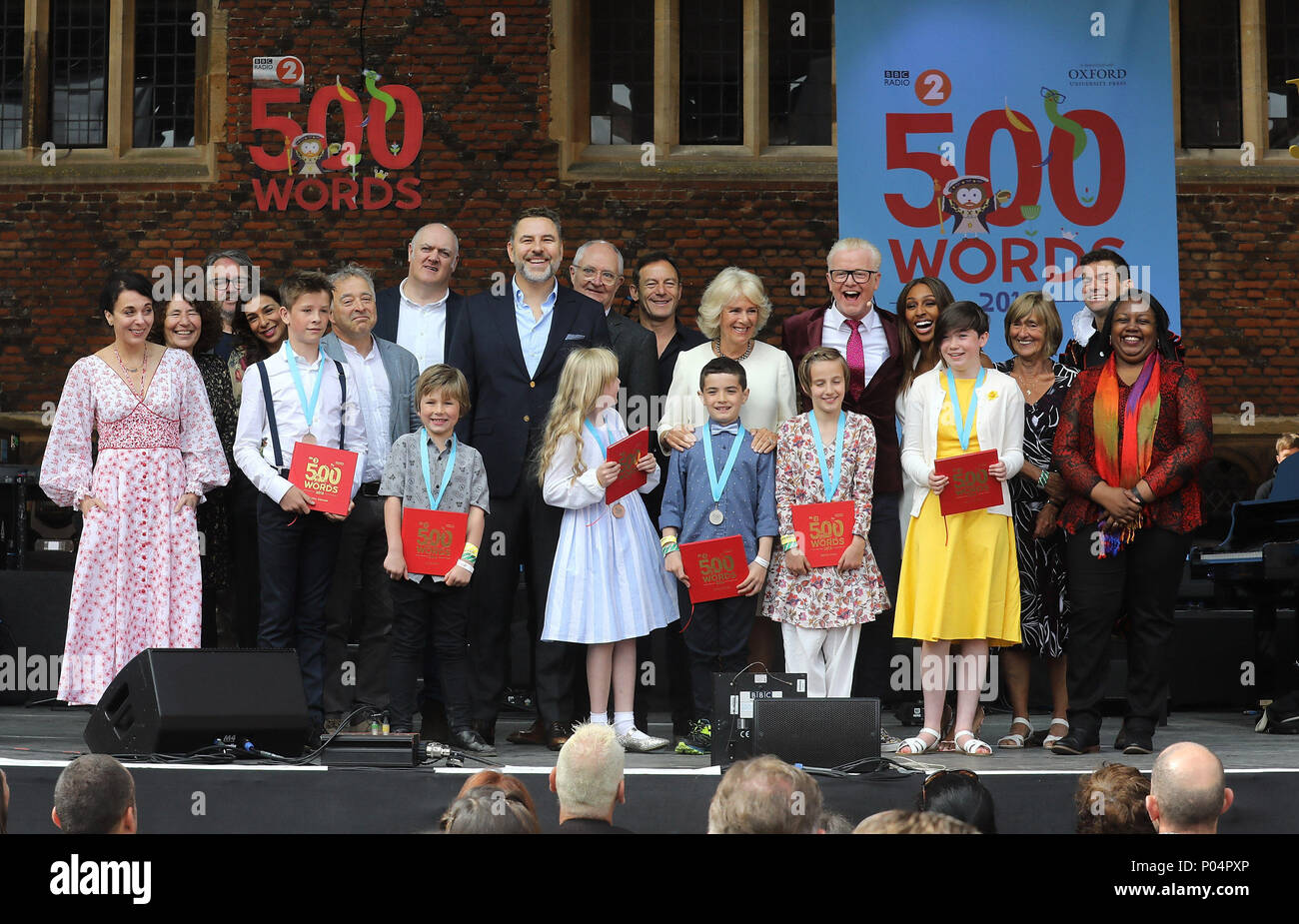 Die Herzogin von Cornwall (Mitte rechts) auf der Bühne mit Celebrities wie Amanda Abbingdon, Shobna Gulati, Dara O'Briain, David Walliams, Jim Broadbent, Jason Issacs, Chris Evans und die sechs siegreichen Kinder bei der Live-übertragung des letzten 500 Wörter von BBC Radio 2 kreatives Schreiben Wettbewerb in Hampton Court Palace in East Molesey. Stockfoto