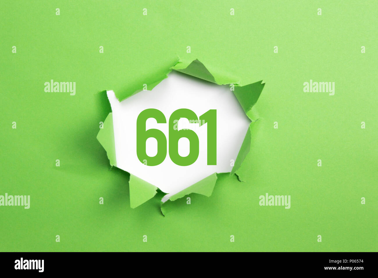 Grüne Nummer 661 auf grünem Papier Hintergrund Stockfoto