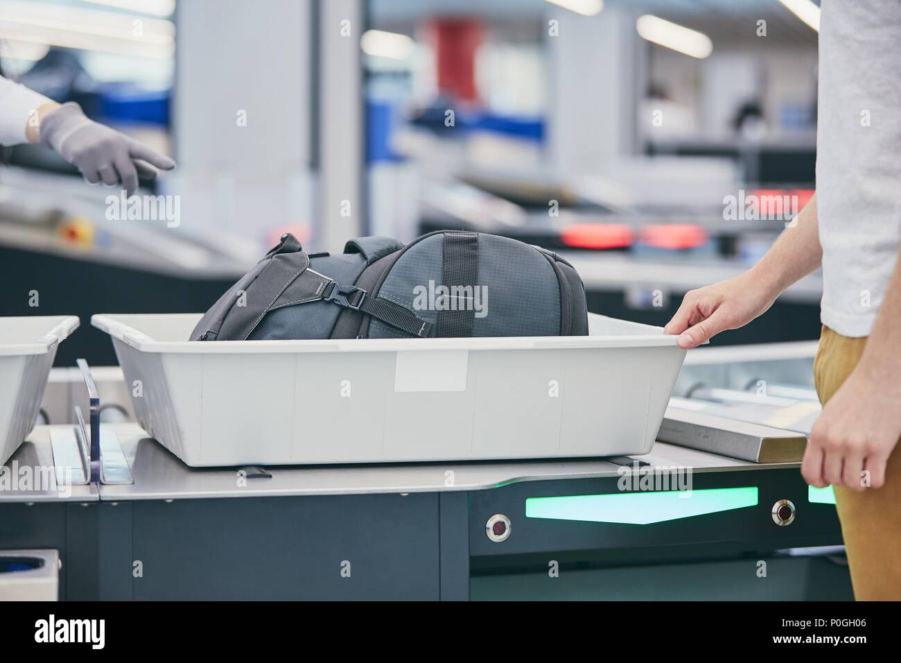 Flughafen Sicherheit prüfen. Junger Mann (Reisenden) warten auf x-ray Control sein Gepäck. Stockfoto