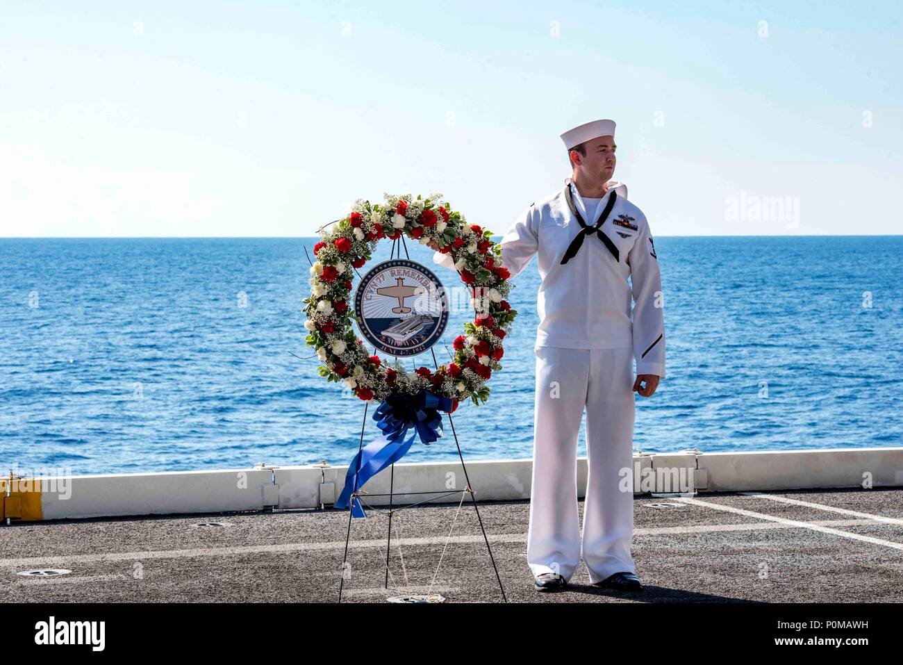 180606-N-UV-609-0160 ATLANTIK (6. Juni 2018) Der Bootsmann Mate 3. Klasse Robert Reilly, von Sayreville, New Jersey, steht neben einer Kranzniederlegung während einer Gedenkveranstaltung für den 76. Jahrestag der Schlacht um Midway an Bord der Flugzeugträger USS George H.W. Bush (CVN 77). Das Schiff ist im Gange, die Durchführung von routinemäßigen Übungen Träger bereit zu halten. (U.S. Marine Foto von Mass Communication Specialist 2. Klasse David Mora Jr.) Stockfoto