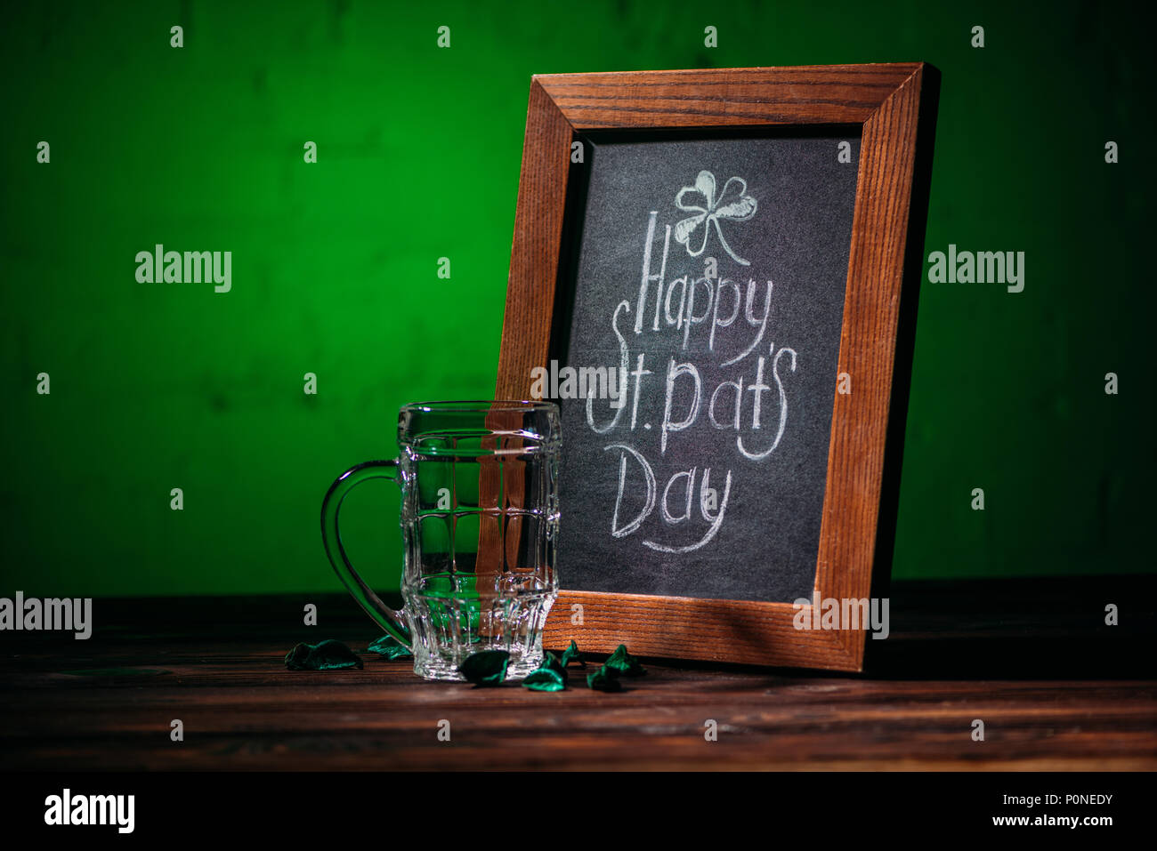 Holzrahmen mit Happy st patricks day Inschrift und leere Bier Glas auf dem Tisch Stockfoto