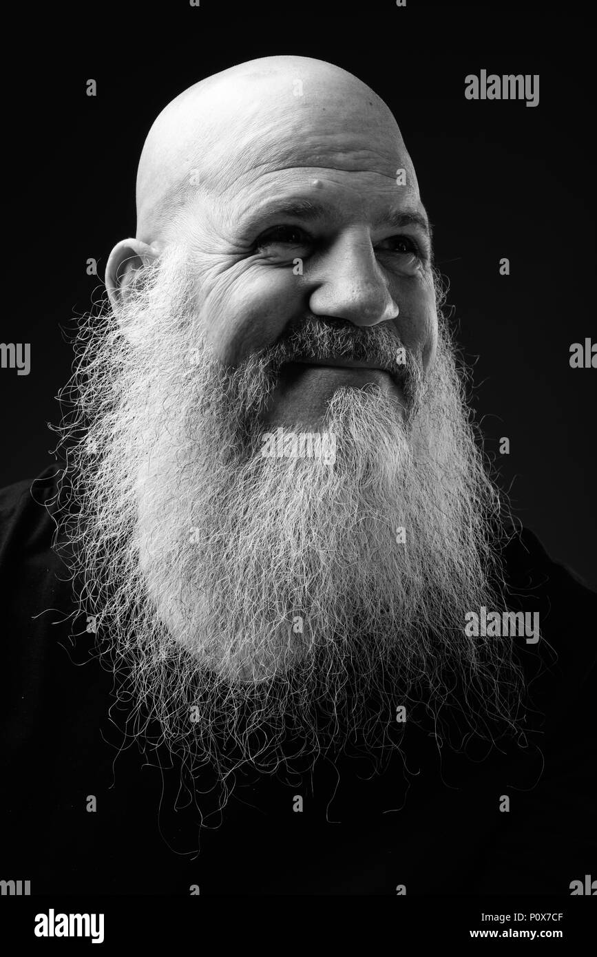 Schwarz-weiß-Porträt zur Reife der glatzköpfige Mann mit langem Bart Stockfoto