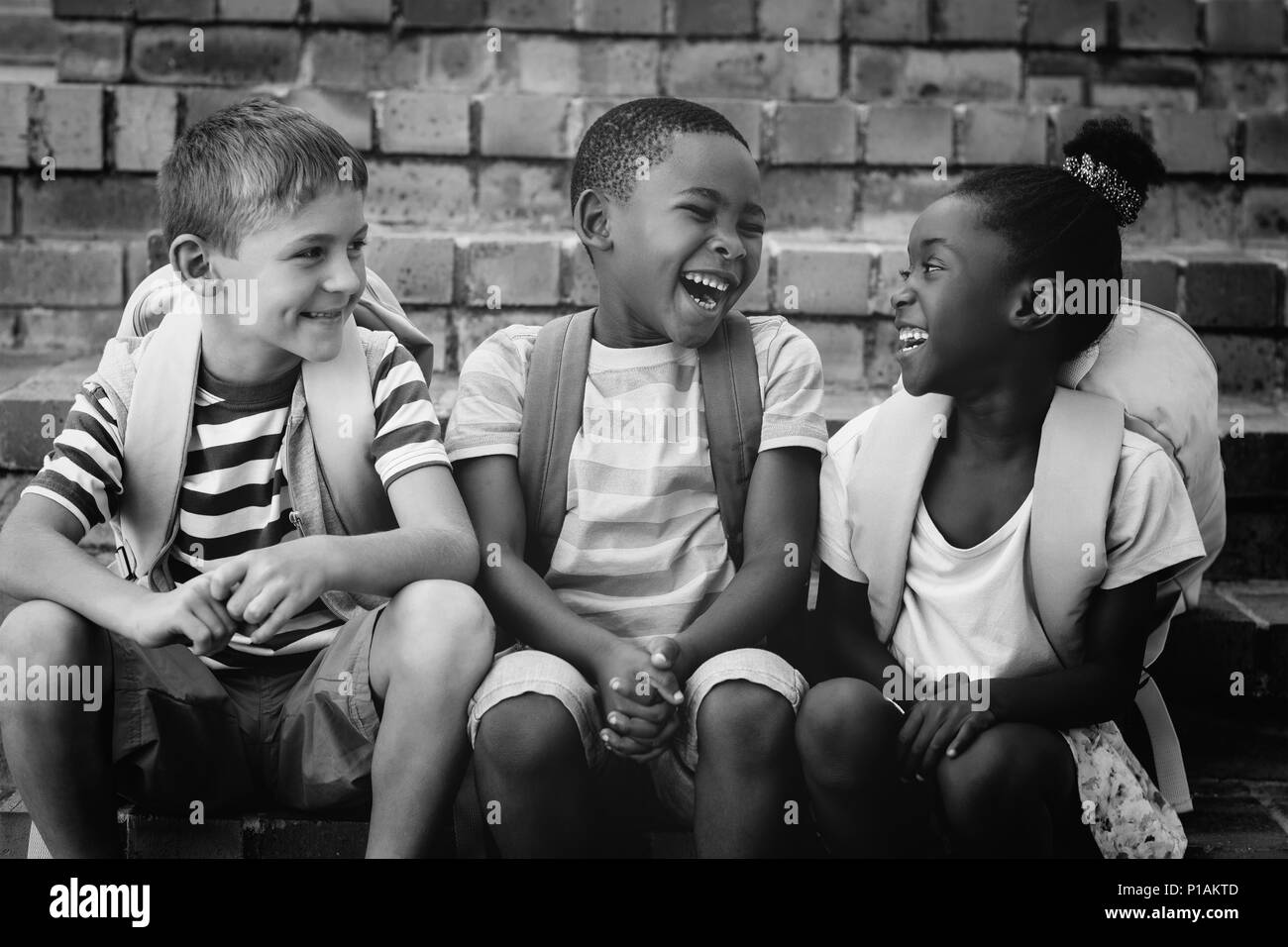 Glückliche Kinder sitzen auf Schritte Stockfoto