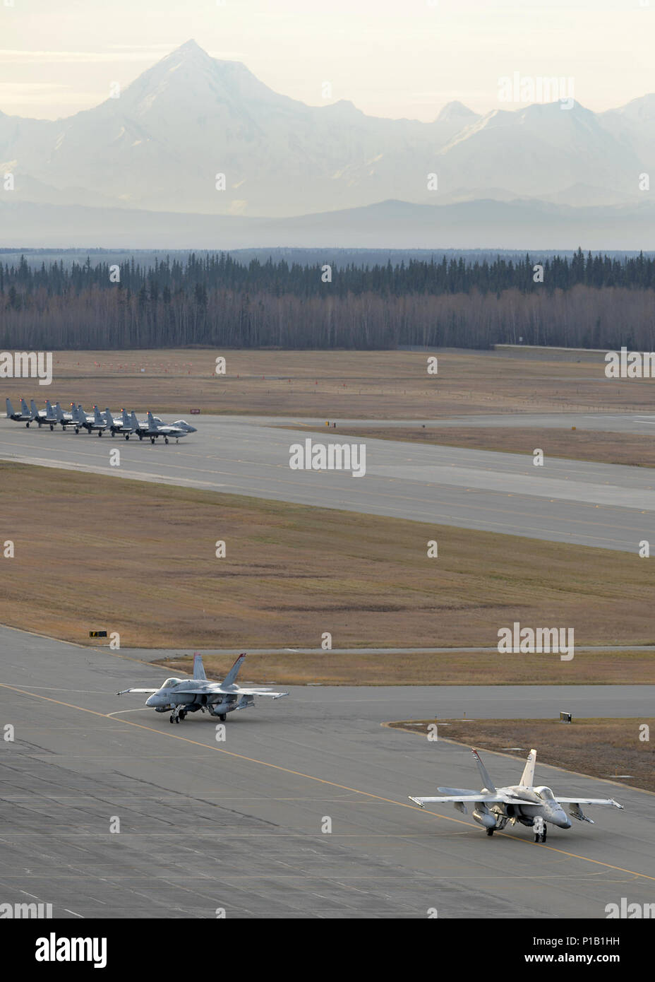 Us Marine Corps F/A-18C Hornet, Marine Fighter Attack Squadron 232 aus der Marine Corps Air Station Miramar, Calif zugeordnet, Taxi vor der US Air Force F-15 Eagle Flugzeuge nach der Rückkehr nach Eielson Air Force Base, Alaska, Oktober 10, 2016, während der roten Fahne - Alaska (RF-A) 17-1. Diese Übung bietet einzigartige Möglichkeiten, verschiedene Kräfte in gemeinsamen, Koalition und multilaterale Ausbildung aus simulierten Stützpunkte zu integrieren. (U.S. Air Force Foto von Master Sgt. Karen J. Tomasik) Stockfoto