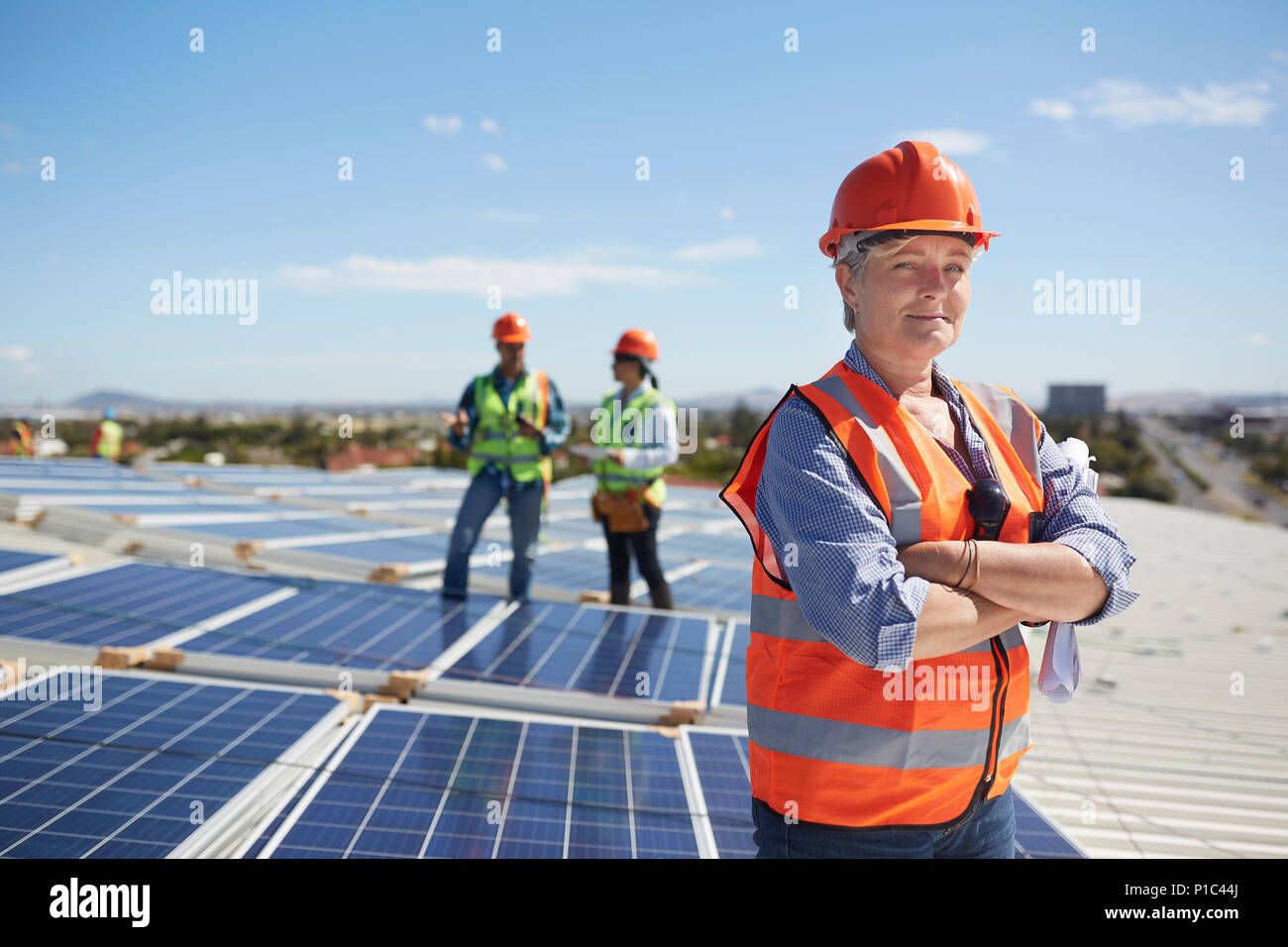 Portrait zuversichtlich Ingenieurin bei Sunny Solarkraftwerk Stockfoto