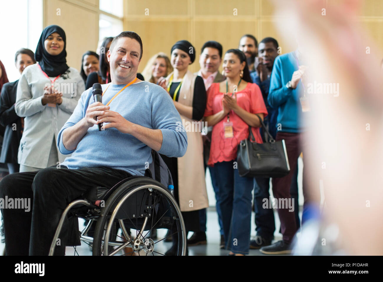 Publikum klatschen für Sprecher männlich im Rollstuhl Stockfoto
