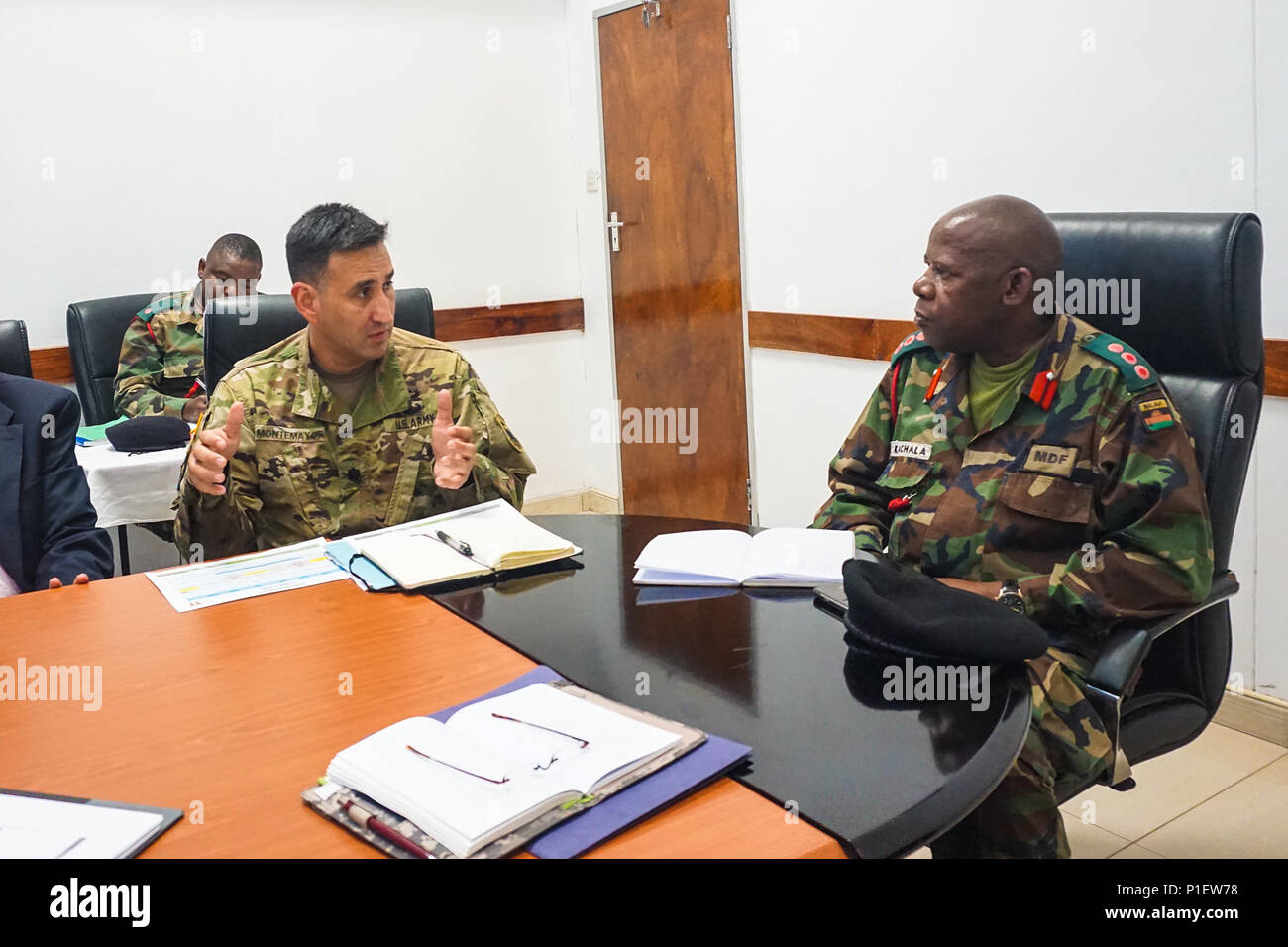 Us-Armee Afrika führen Tagungsplaner Oberstleutnant Hector Montemayor diskutiert eine Vorgeschlagene Zeitleiste der Ereignisse mit Malawi Defence Force Col. Cleveland Kachala während der anfänglichen Planung Ereignis für das afrikanische Land Kräfte Gipfel 2017 in Lilongwe, Malawi, Okt. 18, 2016. Koester ist eine jährliche, einwöchigen Seminar in dem Land Kraft Leiter aus ganz Afrika für offenen Dialog zu diskutieren und kooperative Lösungen für regionale und überregionale Herausforderungen und Bedrohungen entwickeln. Stockfoto