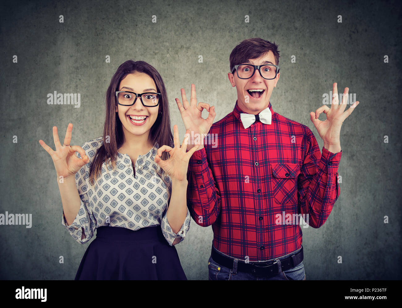 Erfolg und Sieg Konzept. Junge lustig Paar showig ok Zeichen zum Ausdruck bringen Spannung, Staunen und Freude Stockfoto