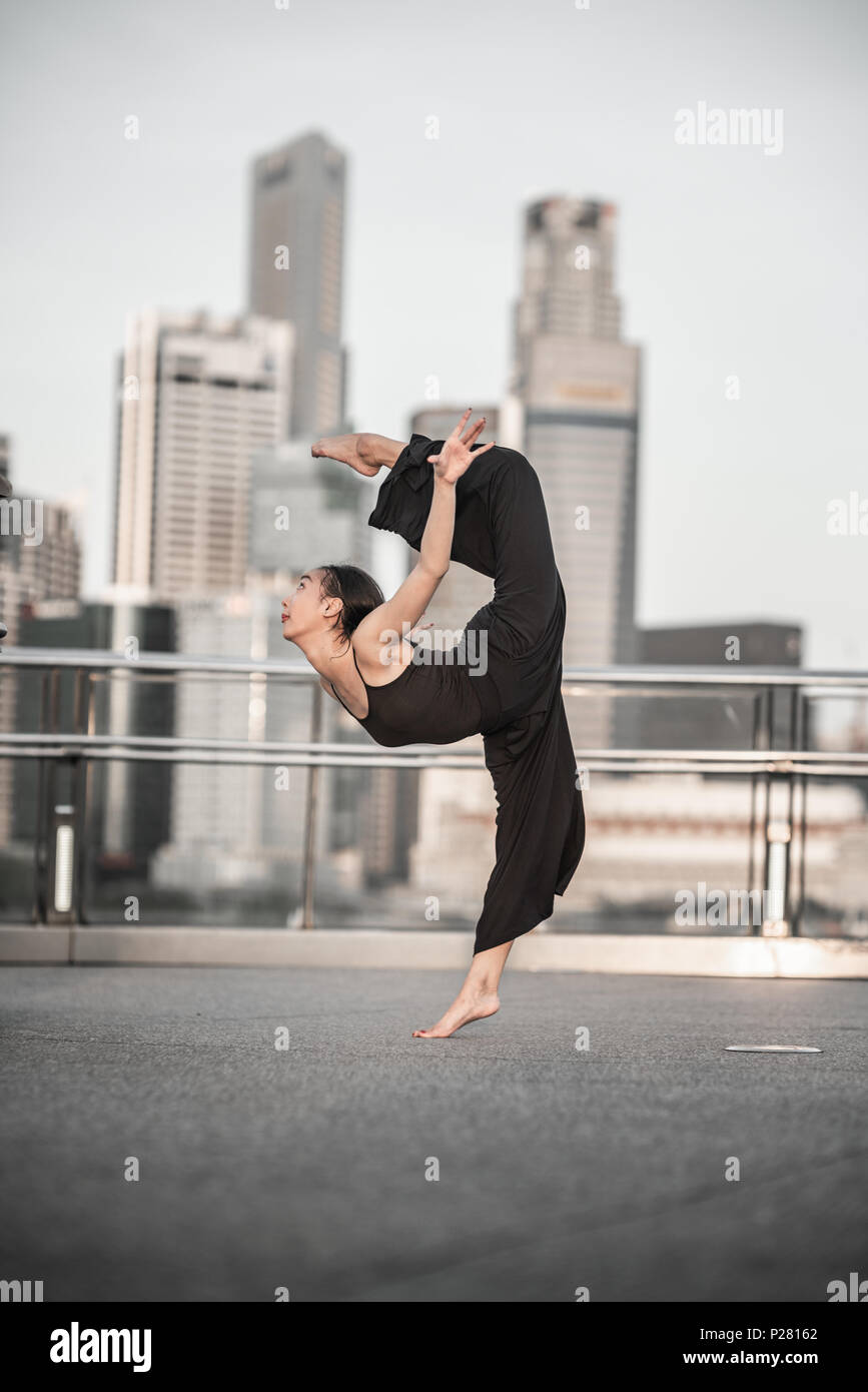 Schöne junge Mädchen tanzen auf einer Brücke Stockfoto