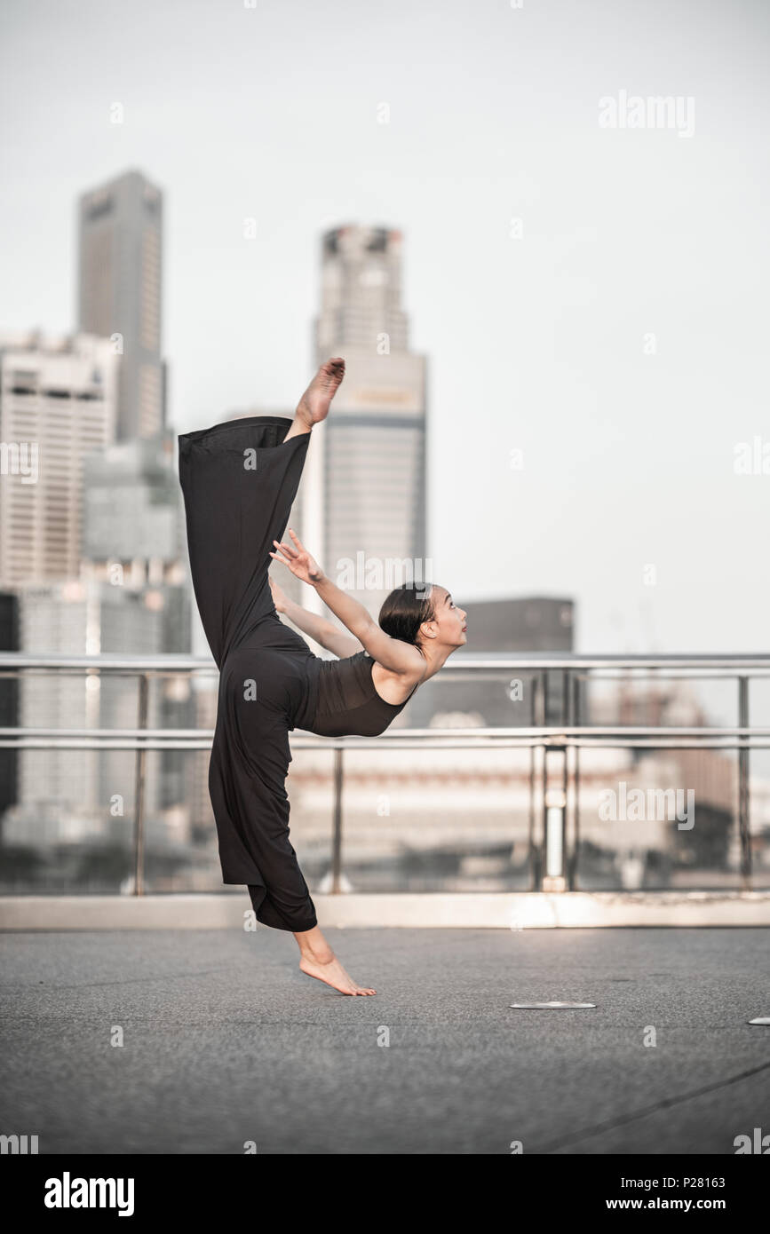 Schöne junge Mädchen tanzen auf einer Brücke Stockfoto