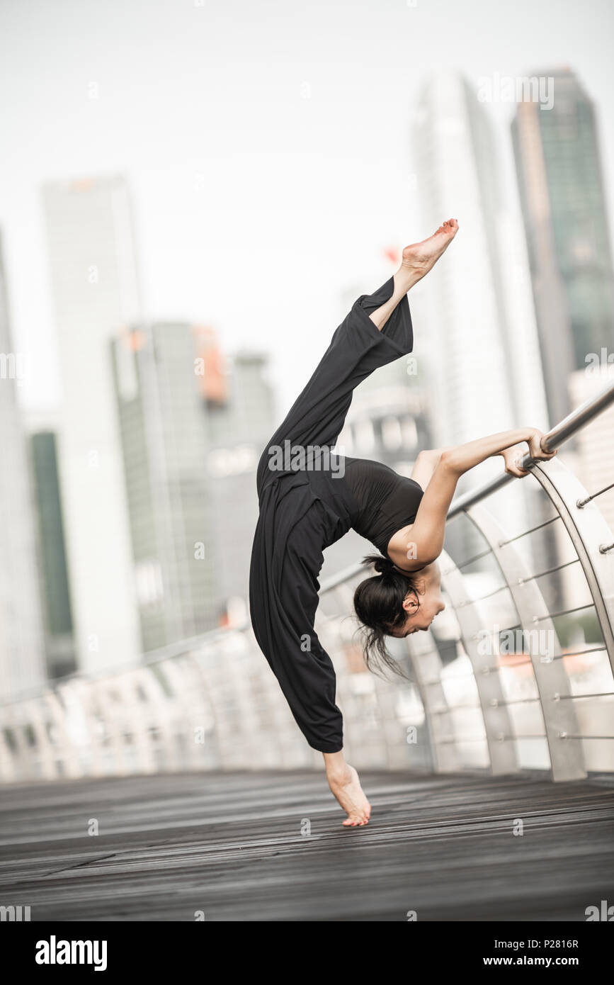 Schöne junge Mädchen tanzen auf einer Brücke Stockfoto