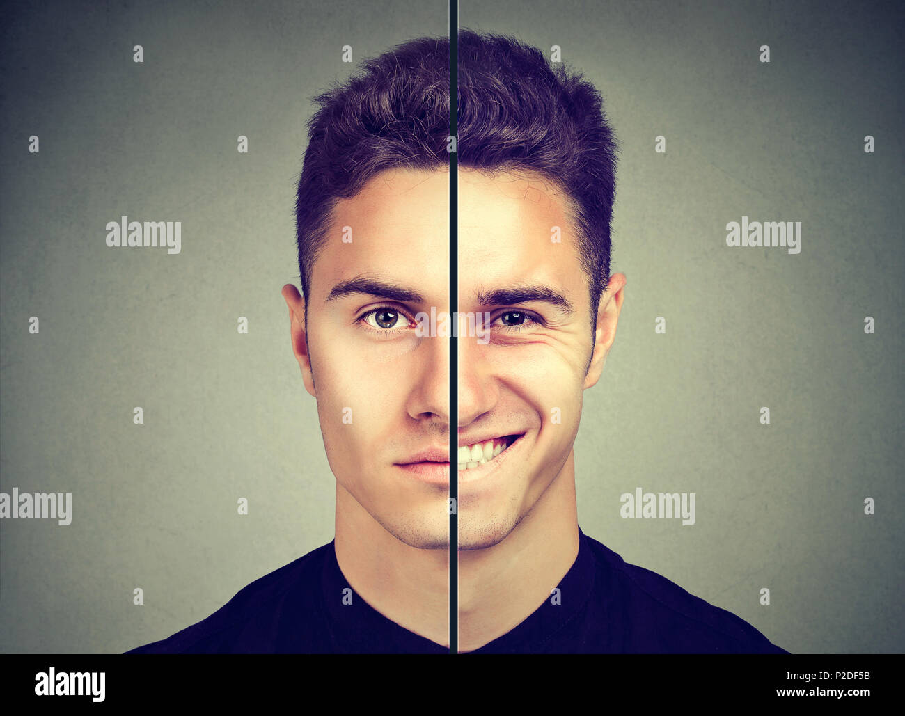 Bipolare Störung. Mann mit einem Gesichtsausdruck auf grauem Hintergrund Stockfoto