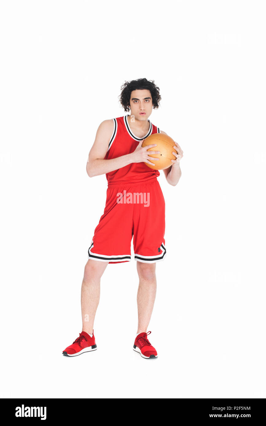 Skinny basketball Player stehend mit Ball in Hand isoliert auf weißem Stockfoto