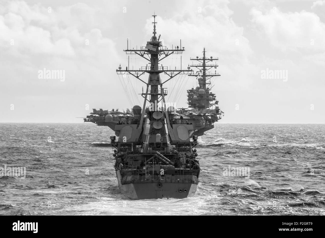 160923-N-XQ 474-077 philippinischen Meer (bis 30. 23, 2016) Der Arleigh-burke-Klasse geführte Anti-raketen-Zerstörer USS Benfold (DDG65) zurück, und der nimitz-Klasse Flugzeugträger USS Ronald Reagan (CVN 76), front, Transit die Philippinische See, die sich in der Ausbildung für ein Foto Übung während der Valiant Shield 2016. Valiant Shield ist eine Biennale, nur in den USA, Feld - Training mit Fokus auf die Integration der gemeinsamen Ausbildung der US-Streitkräfte. Dies ist die sechste Übung in der Valiant Shield-Serie, die 2006 begann. Benfold und Reagan sind auf Patrouille mit Carrier Strike Group (CSG 5) im philippinischen Meer supportin Stockfoto