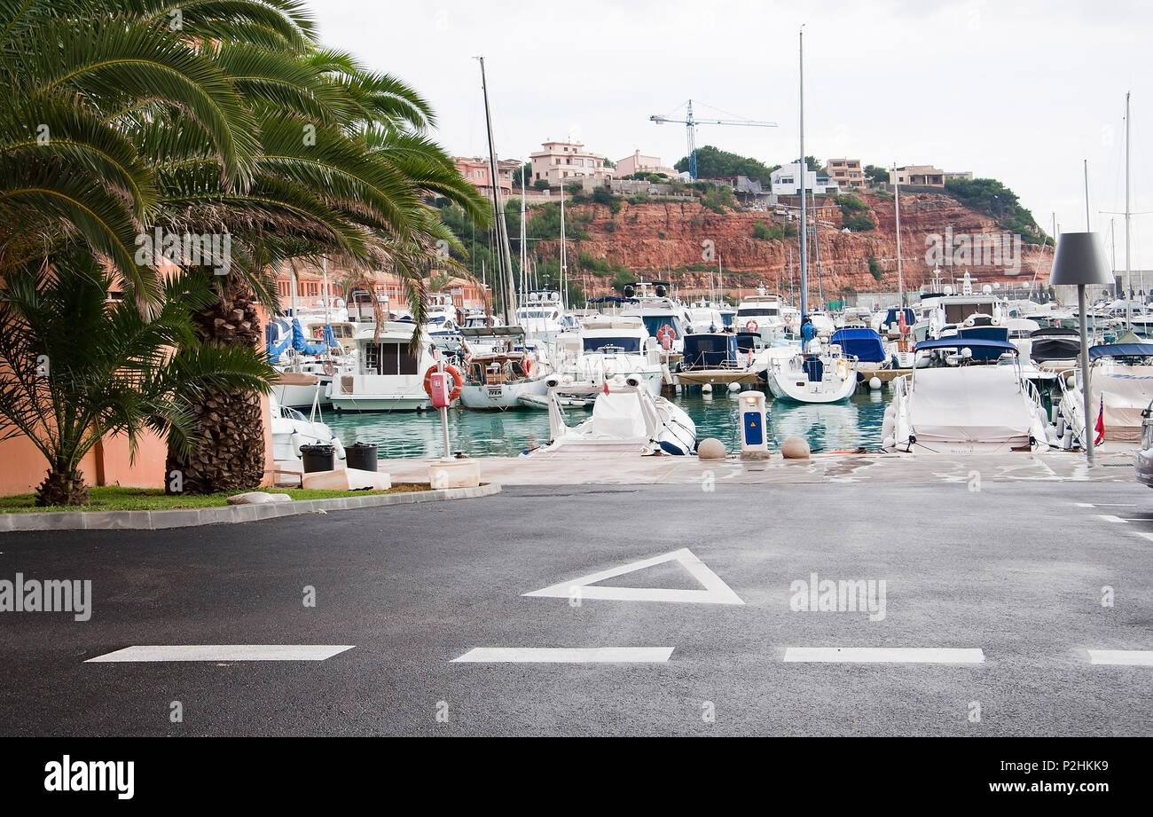 PORT ADRIANO mallorca, mallorca, Spanien - 15. NOVEMBER 2011: Boote in der Marina in Gebäuden auf rotem Sedimentgestein vertäut am 15. November 2011 in Port Adriano, Stockfoto