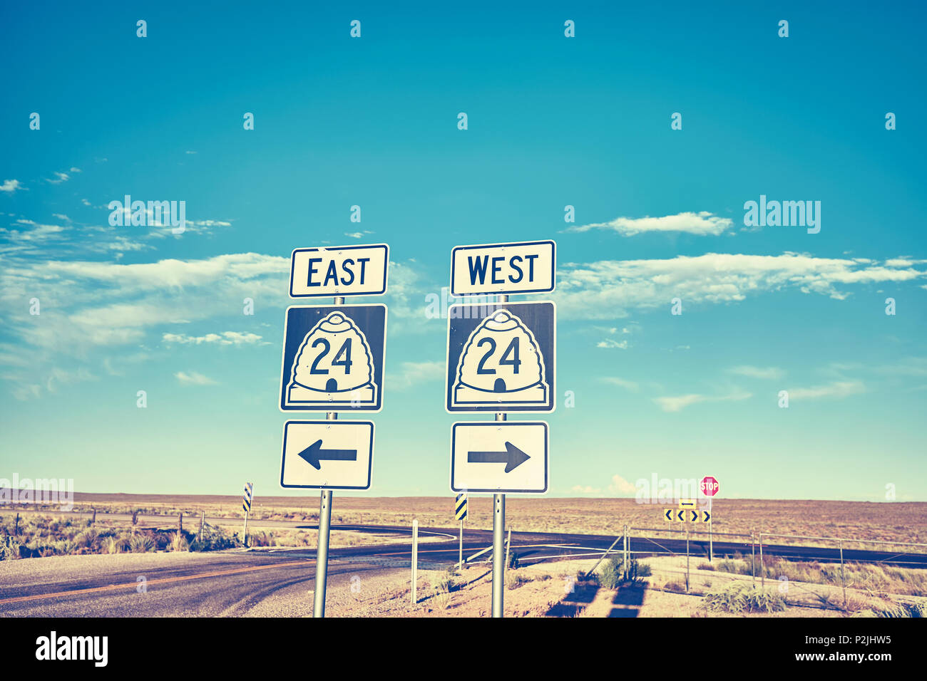 Ost oder West, retro Farben Foto von Verkehrszeichen bei Sonnenuntergang, Auswahl und Travel Concept. Stockfoto