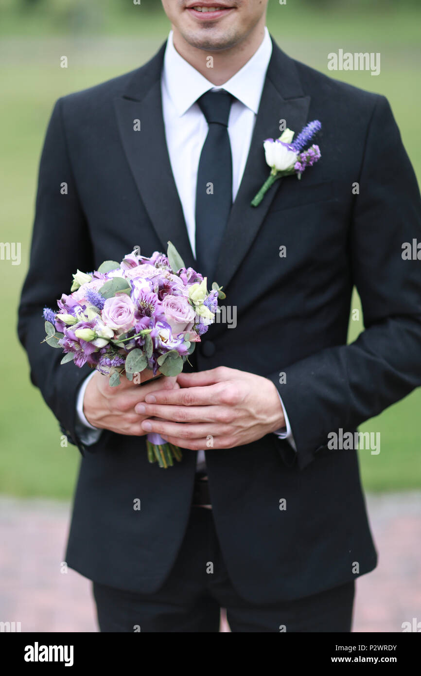 Bräutigam in schwarzen Anzug und Krawatte, Blumenstrauß Stockfotografie -  Alamy
