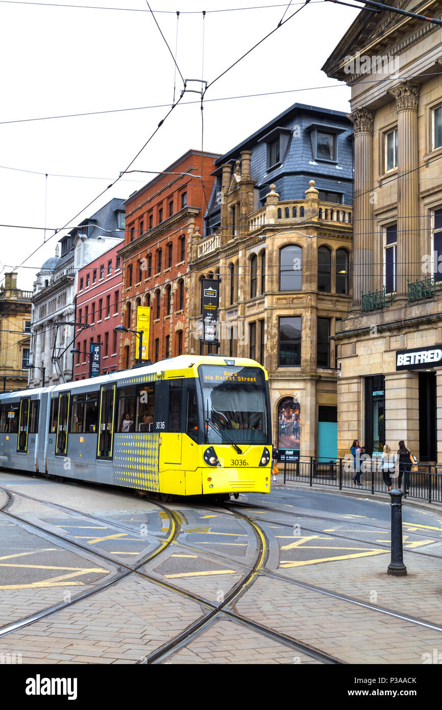 Gelb und Grau Straßenbahn durch Central Manchester, UK, Stockfoto