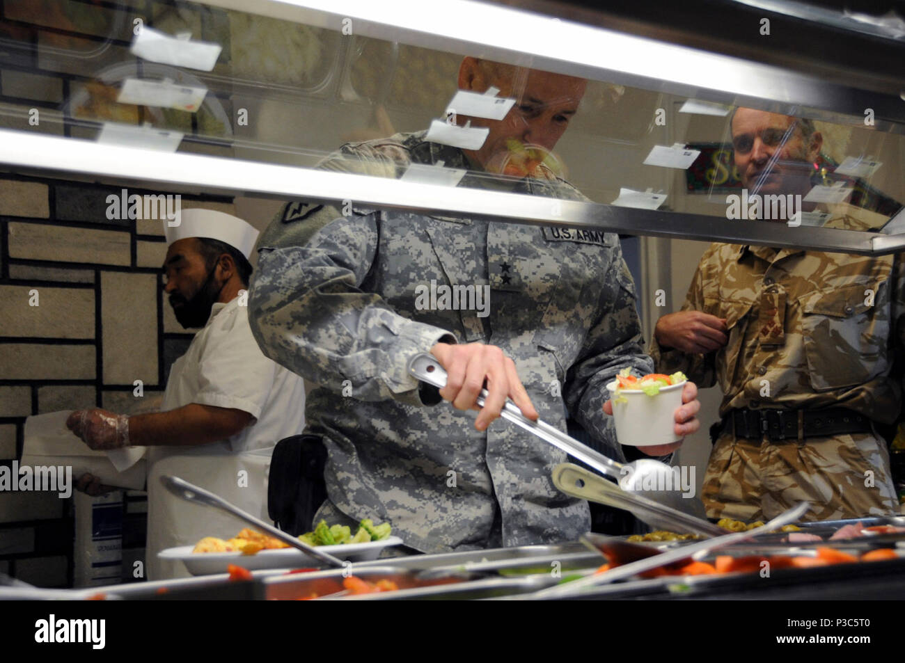 KABUL, Afghanistan - Generalmajor Michael Bednarek, Commander Erste Armee Division Ost, dient sich selbst am "Ziege" Speisesaal Salatbar, am Lager Eggers, Afghanistan, vor eine Strategie Abendessen am 10.12.1009. Gastgeber der Sitzung war Generalleutnant William B. Caldwell, IV, Kommandeur der NATO Training Mission - Afghanistan, und Generalleutnant Thomas G. Miller, Kommandierender General der ersten Armee, Brig. Gen. Gary S. Patton, stellvertretender Kommandierender General, Programme und Brig. Simon Levey, Commander kombinierten Training Advisory Group. Die Generäle diskutiert bessere Auslastung der militärischen Kräfte in o Stockfoto