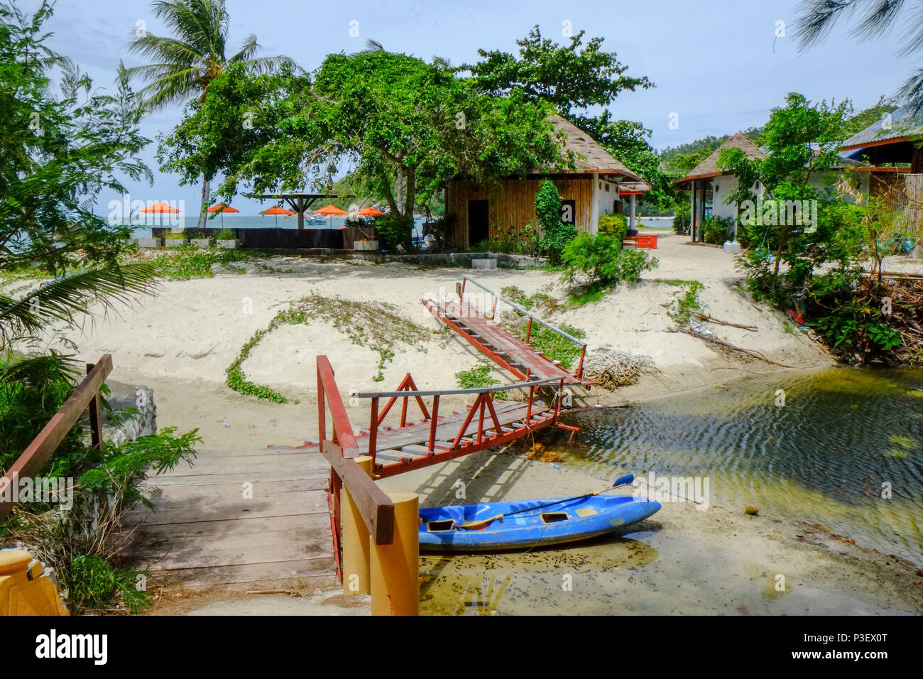 Strom fließt durch eine Thai Resort Hotel in Koh Phangan, Thailand. Das Resort Bungalows können im Hintergrund gesehen werden. Stockfoto
