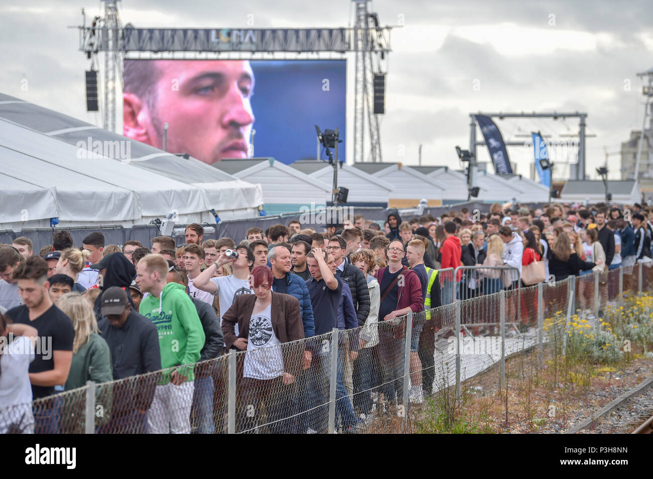 Brighton, UK. 18 Juni, 2018. England Fußballfans beobachten Sie das Spiel auf einem riesigen Bildschirm auf Brighton Seafront, wie sie gegen Tunesien bei der WM in Russland Kreditkarte spielen: Simon Dack/Alamy leben Nachrichten Stockfoto