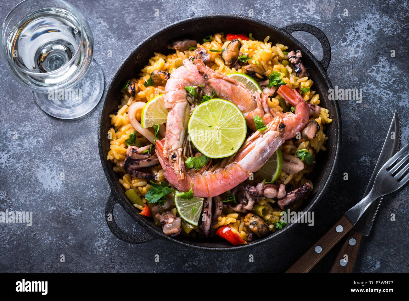Meeresfrüchte Paella. Traditionelle spanische Gerichte, europäische Küche. Draufsicht auf dunklen Tisch aus Stein. Stockfoto