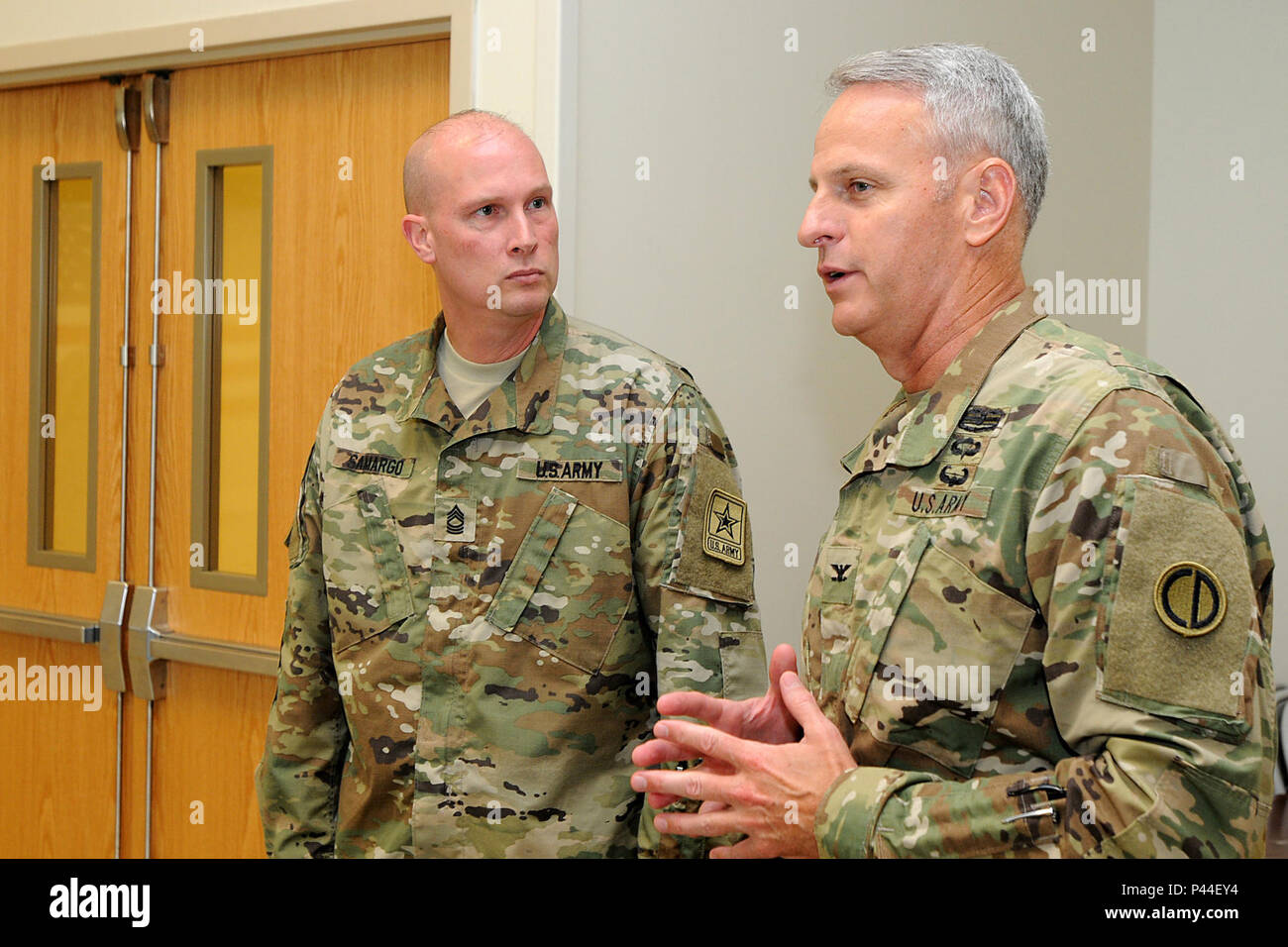 Armee Master Sgt. James Samargo, Links, Büro des Chief, Armee, unterhält sich mit Armee-reserve Oberst Robert S. Cooley, stellvertretender kommandierender Offizier der 85. der Armee finden Unterstützt den Befehl, vor dem ein gefallener Soldat Memorial hielt am 25. Juni 2016. Die Gedenkstätte statt an der dritten Bataillon, 383 Regiment in St. Louis war zu Ehren, und erinnern Sie sich Kapitän Antonio D. Braun, ein 3-383 rd Soldat, der in der jüngsten Nachtclub schießen in Orlando, Florida, getötet wurde. (U.S. Armee Foto von Sgt. Aaron Berogan/Freigegeben) Stockfoto