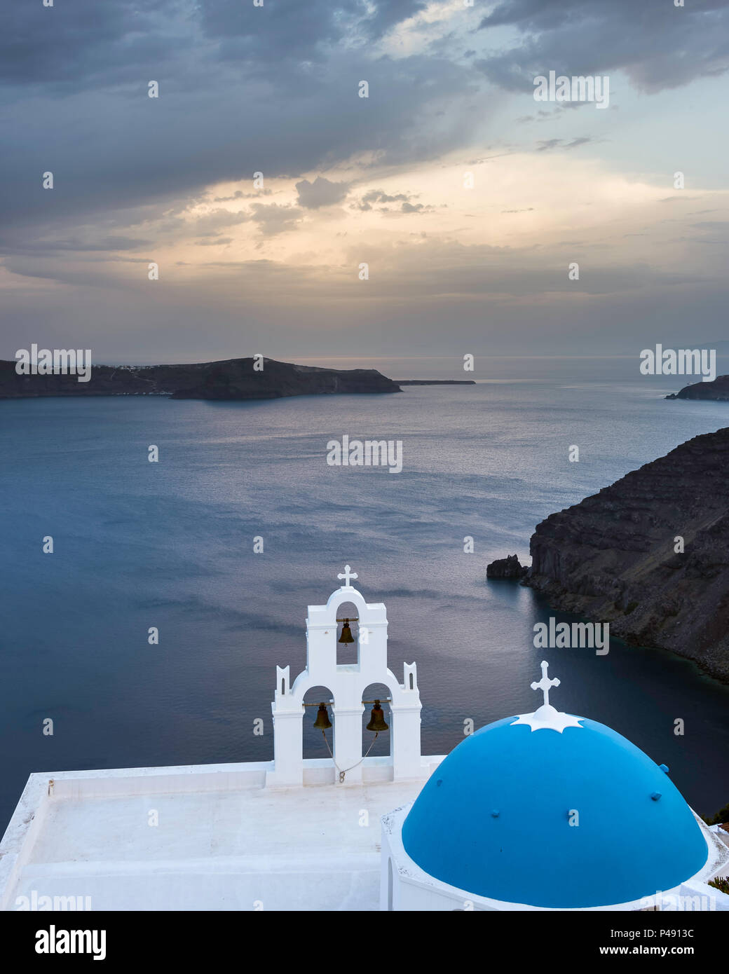 Die drei Glocken von Fira mit Blue Dome, einer griechisch-orthodoxen Kirche auf der Spitze einer Klippe in der Nähe der Stadt Fira auf der Insel Santorini, Griechenland Stockfoto