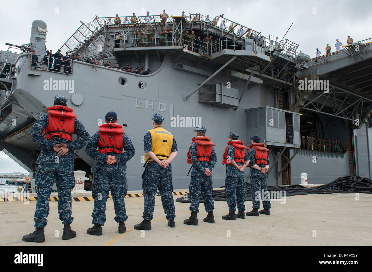 160625-N-QM 905-079 Norfolk, Virginia (25. Juni 2016) Line Handler stand in Bildung als USS Wasp entfaltet (LHD1) als Teil der Wasp Amphibious Ready Gruppe (WSP ARG) zur Unterstützung der Maritime Security Operations und Theater Sicherheit Zusammenarbeit in den USA am 5. und 6 Flotte Verantwortungsbereiche. WSP ARG umfasst amphibischen Squadron 6, USS Wasp, USS San Antonio (LPD 17), USS Langley (LSD 41) und dem 22 Marine Expeditionary Unit. (U.S. Marine Foto von Mass Communication Specialist 3. Klasse Shelby Tucker/Freigegeben) Stockfoto