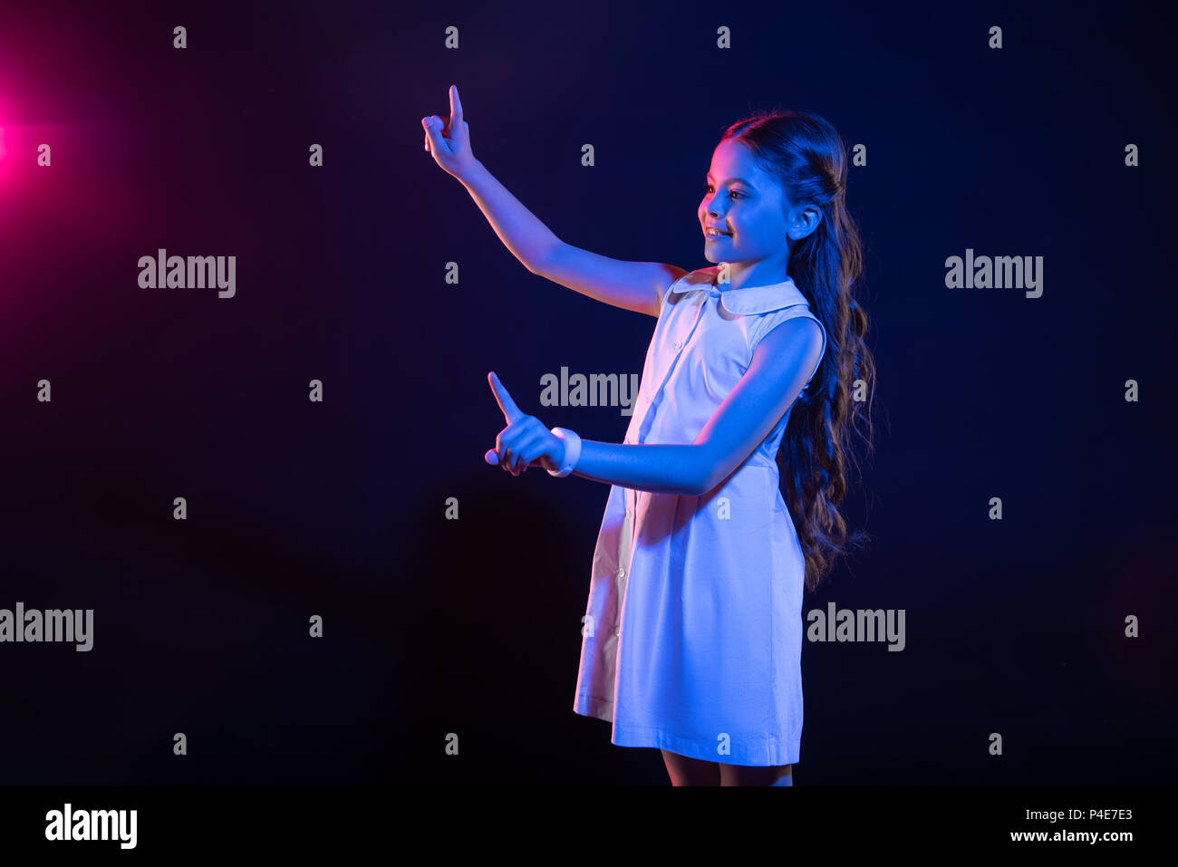 Glückliche Schülerin imaginären Tasten drücken Stockfoto