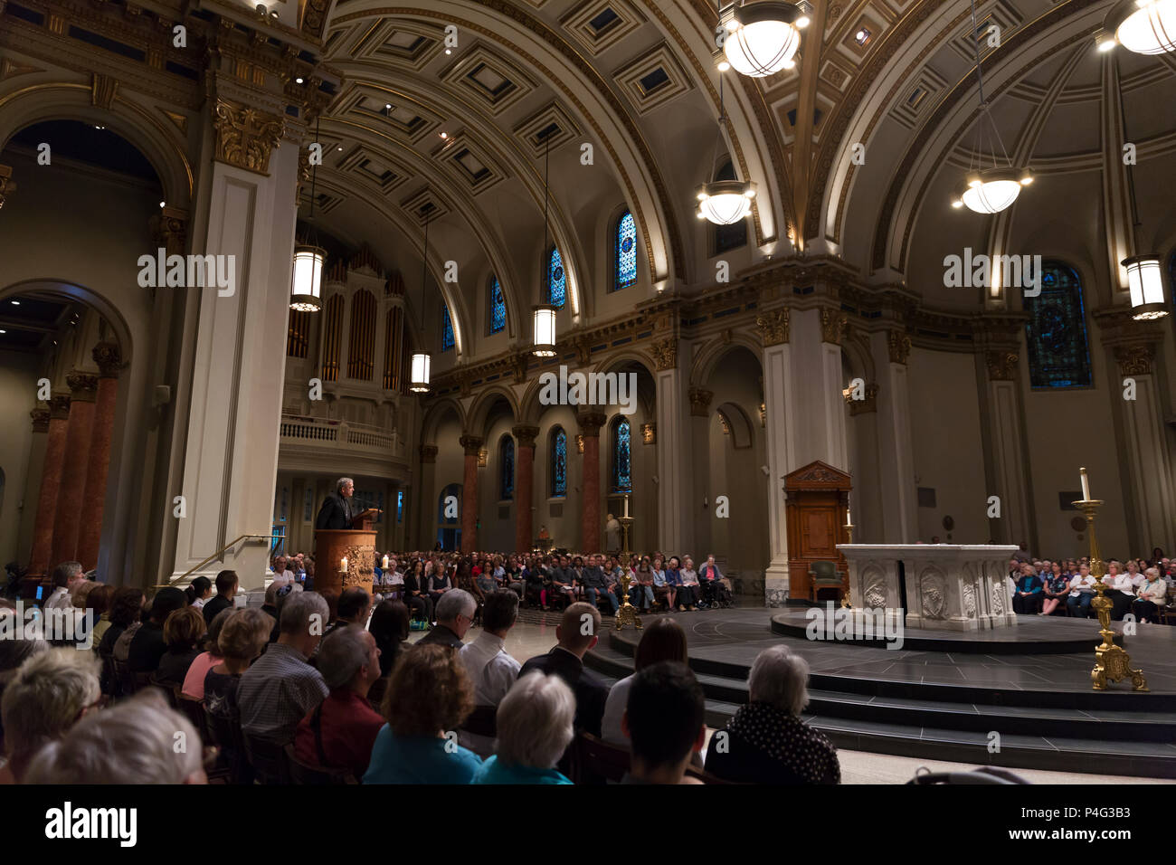 Seattle, USA. 21. Juni 2018. Ein Mitglied des Klerus Adressen Verfechter am St. James Cathedral. Hunderte von Anhängern in der St. Mark's Episcopal Cathedral in Capitol Hill für einen interreligiösen Gebet und Mahnwache in Unterstützung von Migranten und Asylbewerbern gesammelten Asylbewerber, die in die USA kommen und die unmenschliche Trennung der Kinder von ihren Eltern zu protestieren. Die beiden Meile" Gebet und Prozession für Familien an der Grenze' begann in Saint Mark's Episcopal Cathedral in endete am St. James Römisch-katholische Kathedrale in der ersten Hügel. Credit: Paul Christian Gordon/Alamy leben Nachrichten Stockfoto