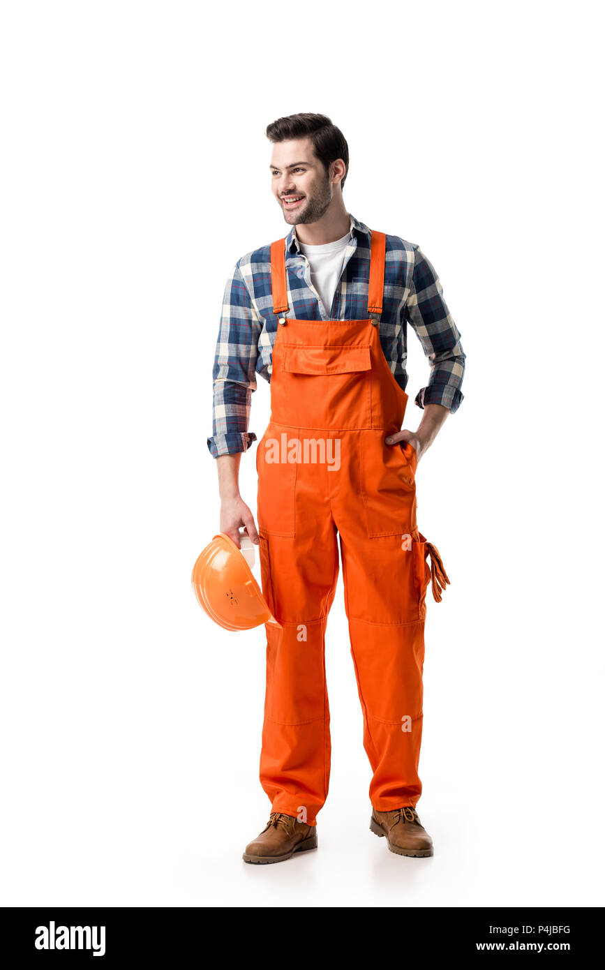 Junge Builder in Orange insgesamt Holding harten Hut isoliert auf weißem Stockfoto