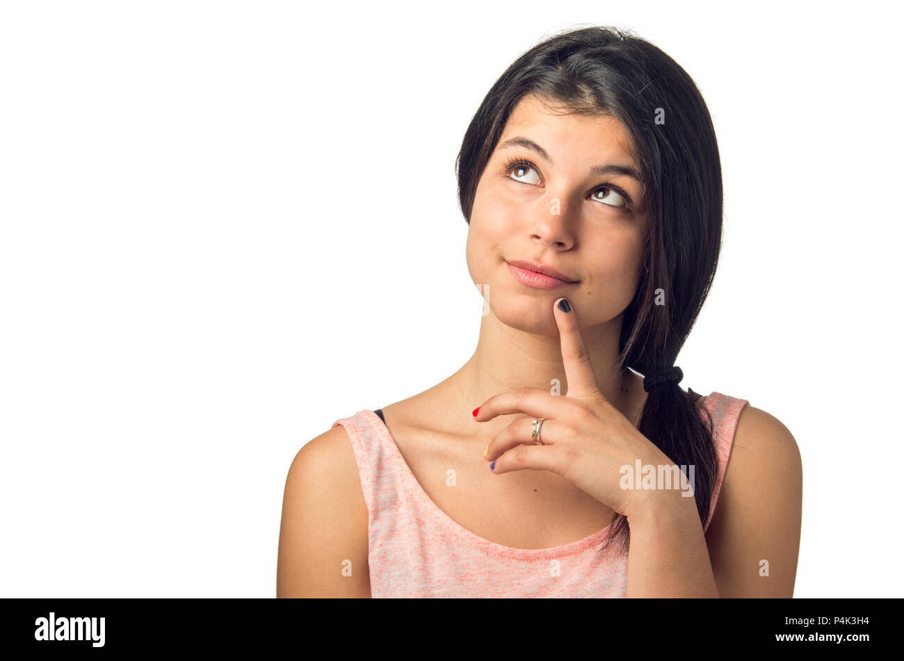 Hübsche brünette Mädchen in einem nachdenklichen Ausdruck mit einem Finger auf ihrem Kinn Stockfoto