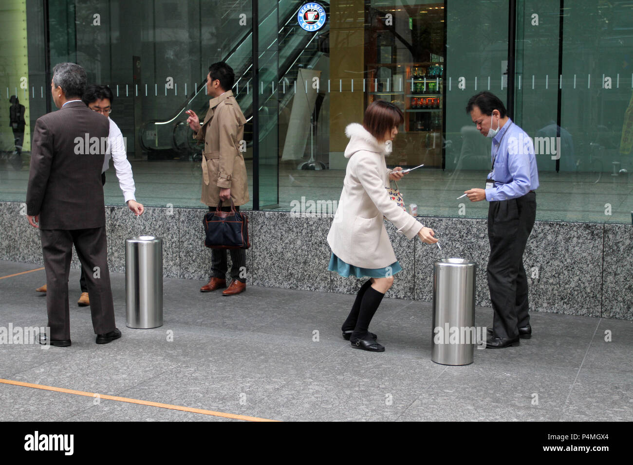 Japanische Leute rauchen Rauchen Zigaretten in einem speziellen Bereich auf der Straße von Tokio, Japan - Jan, 24, 2011. Stockfoto