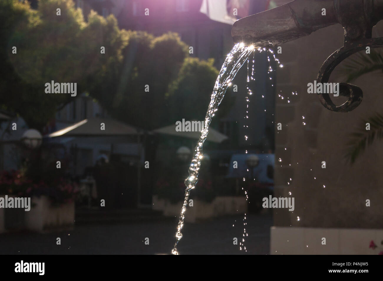Messing antik Brunnen mit schimmernden Wasser im Wasserbehälter an einem sonnigen Tag Stockfoto