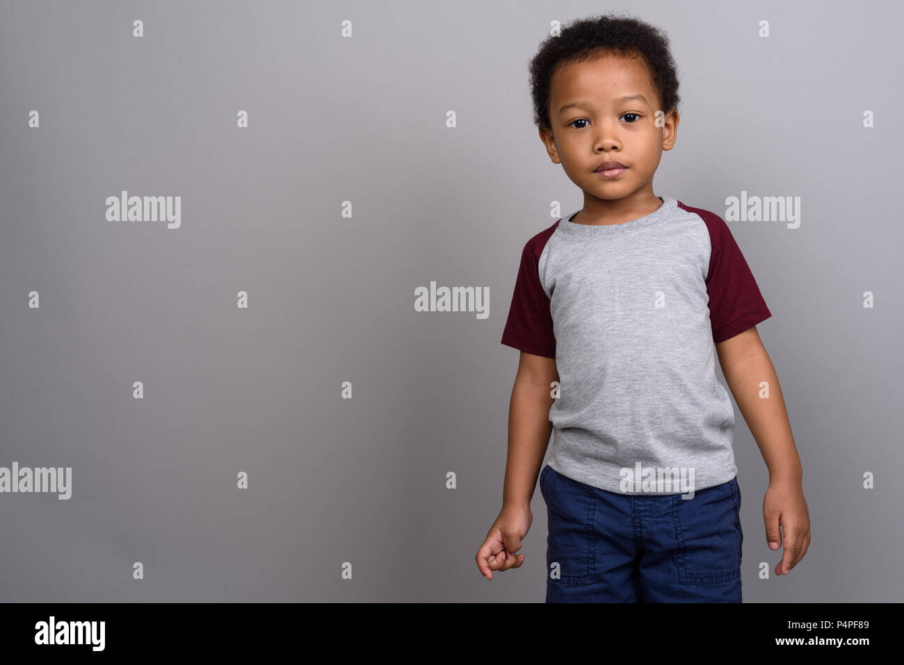 Junge niedlichen afrikanischen Jungen gegen grauer Hintergrund Stockfoto