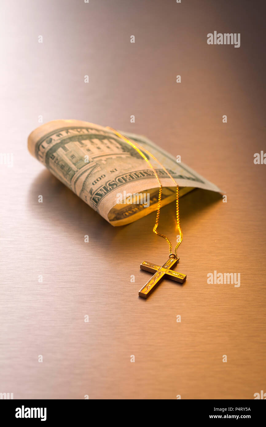 Geld und Kreuz und metallischen Hintergrund Stockfoto