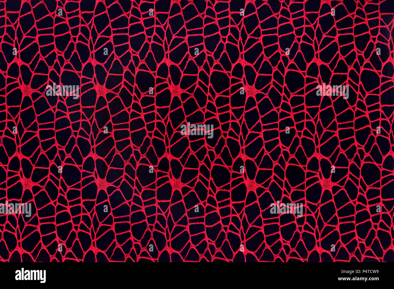 Zusammenfassung Hintergrund aus Gewebe aus roten Fäden auf einem schwarzen Hintergrund. Stockfoto