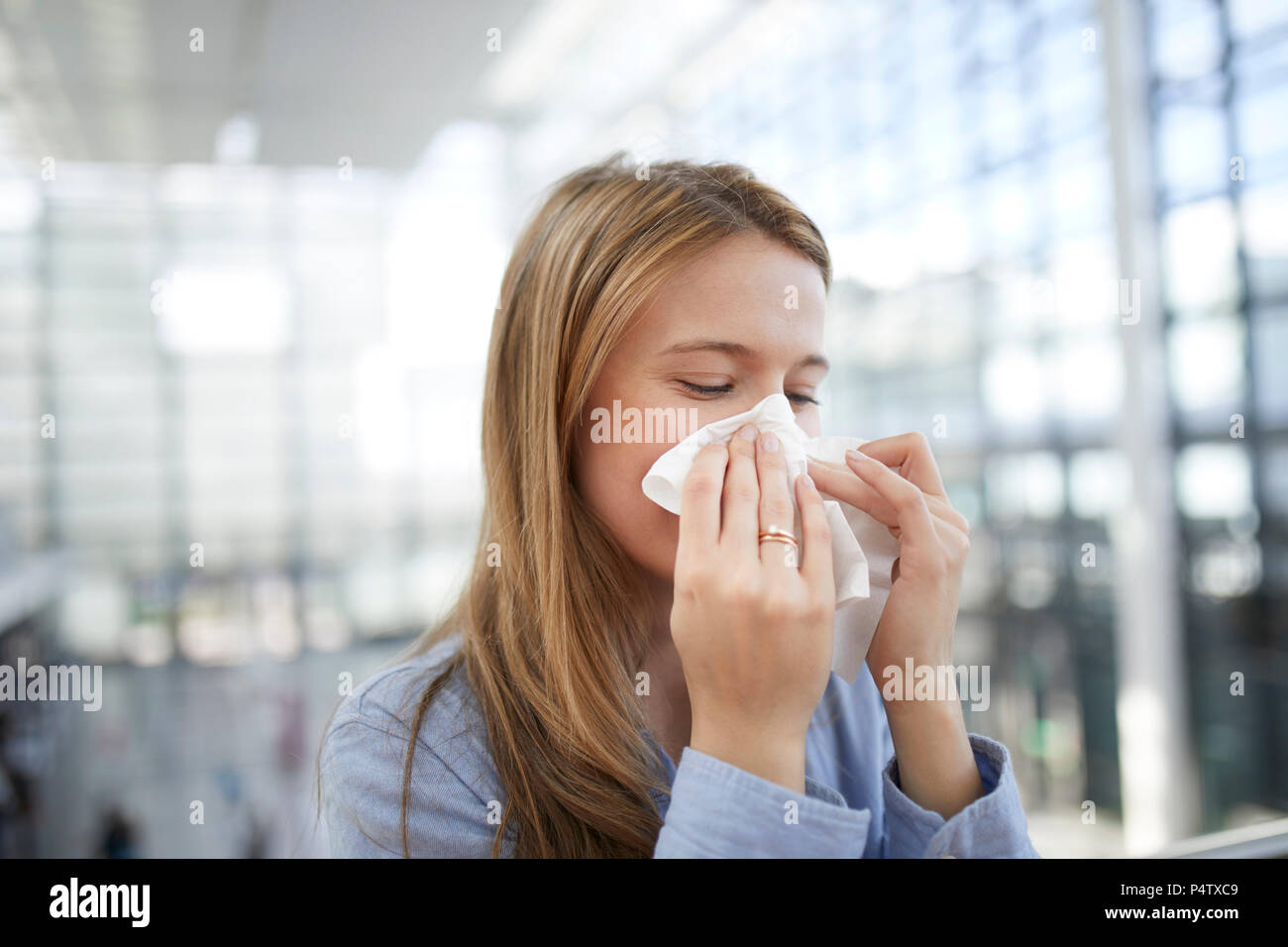 Junge Frau bläst Nase Stockfoto