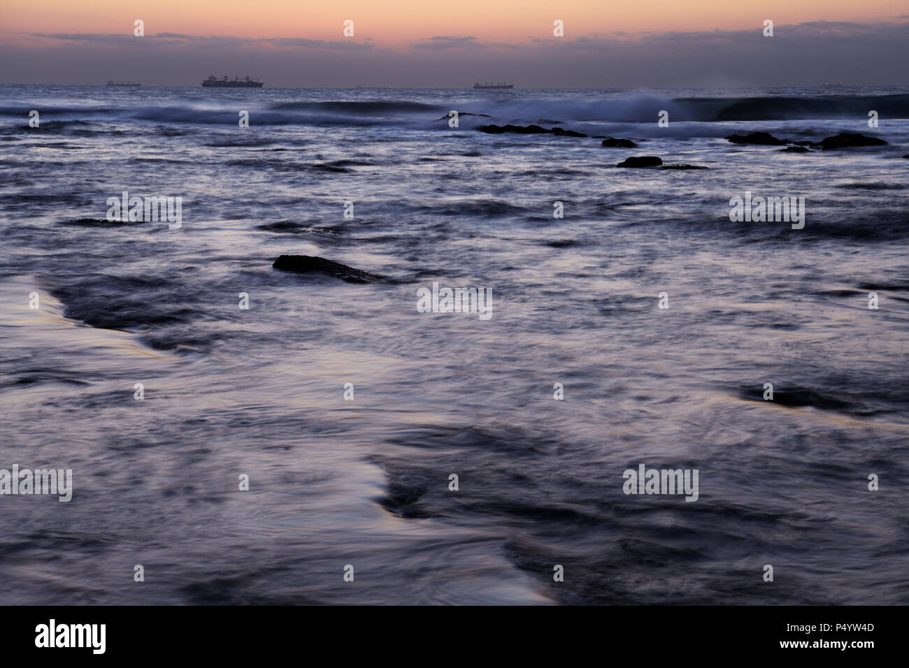 Durban, KwaZulu-Natal, Südafrika, Seascape, Schiffe, die am Horizont, Tagesanbruch, Aussicht auf den Indischen Ozean, Wellen, Umhlanga Rocks Beach, Blur, Landschaft Stockfoto
