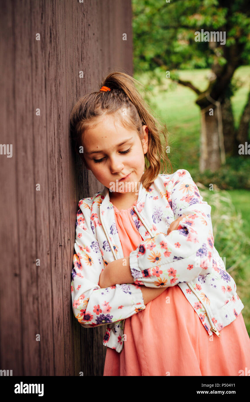 Porträt von trauriges Mädchen aus Holz Wand gelehnt Stockfoto