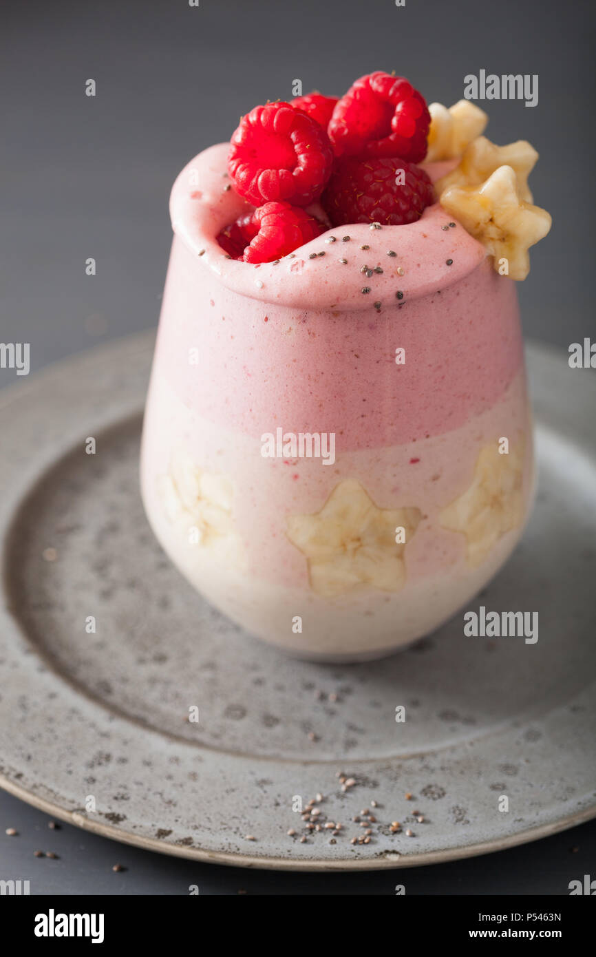 Gesunde layered Himbeere Banane Smoothie in Glas Stockfoto